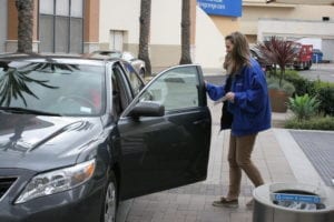 Our "valet-for-a-day," Becky, helping a customer out of their car